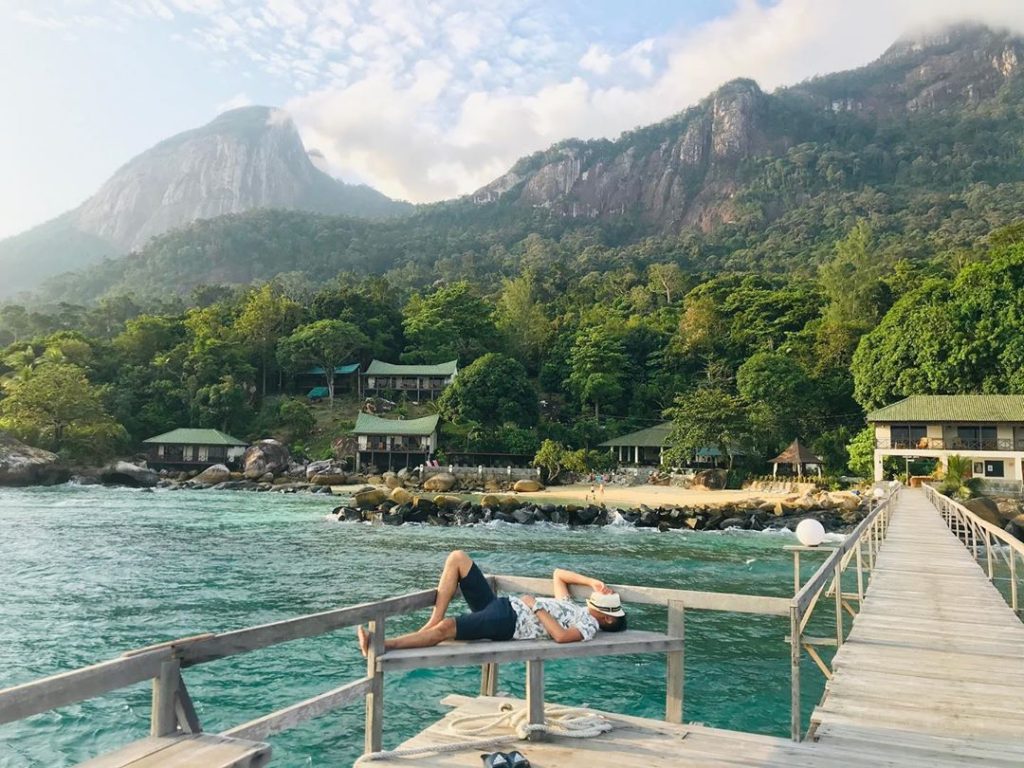 guy lying down with tioman dragon horn in background