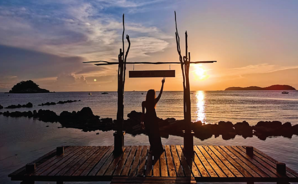 girl posing in front of sunset tioman