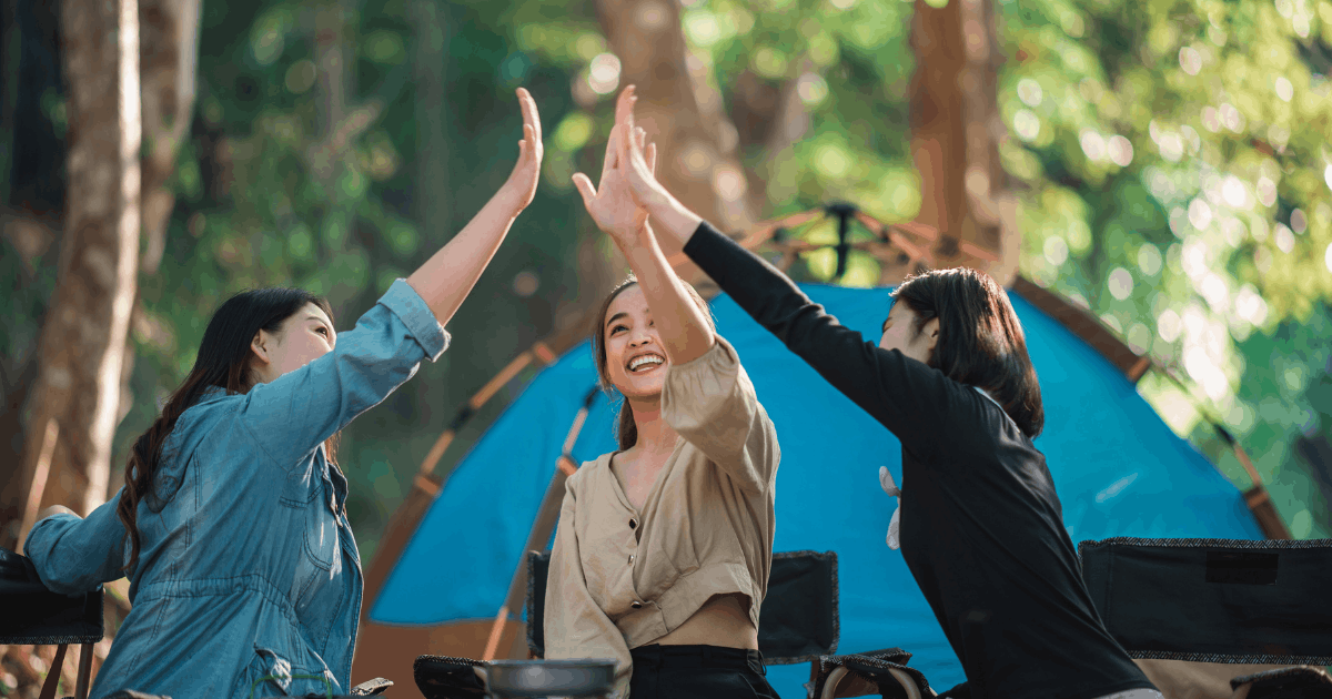 girls celebrating camping